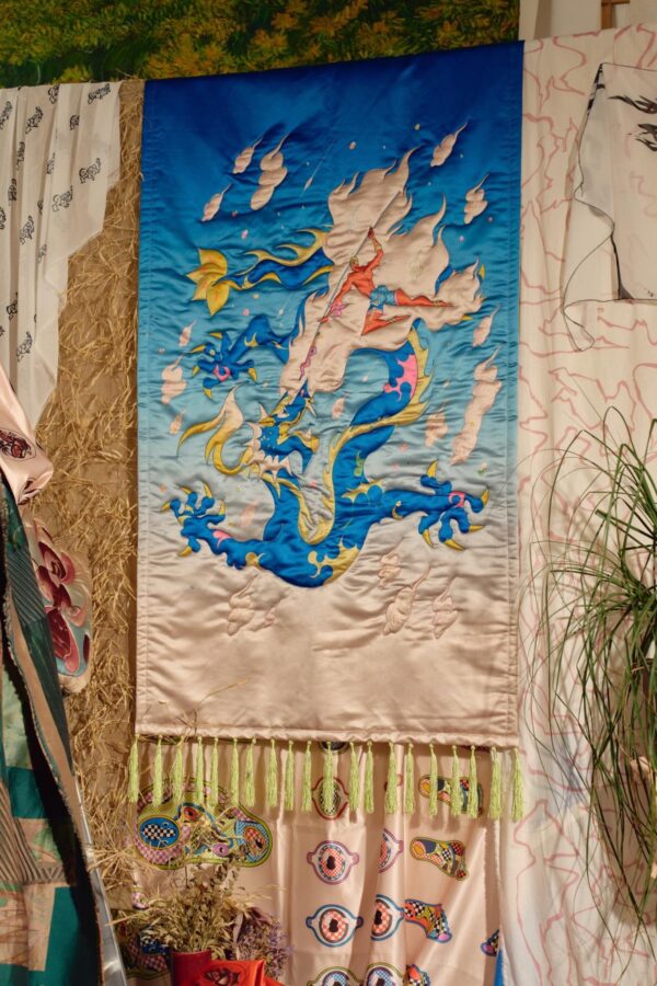 Dragon Tapestry, a quilted wall hanging of a figure riding a blue dragon