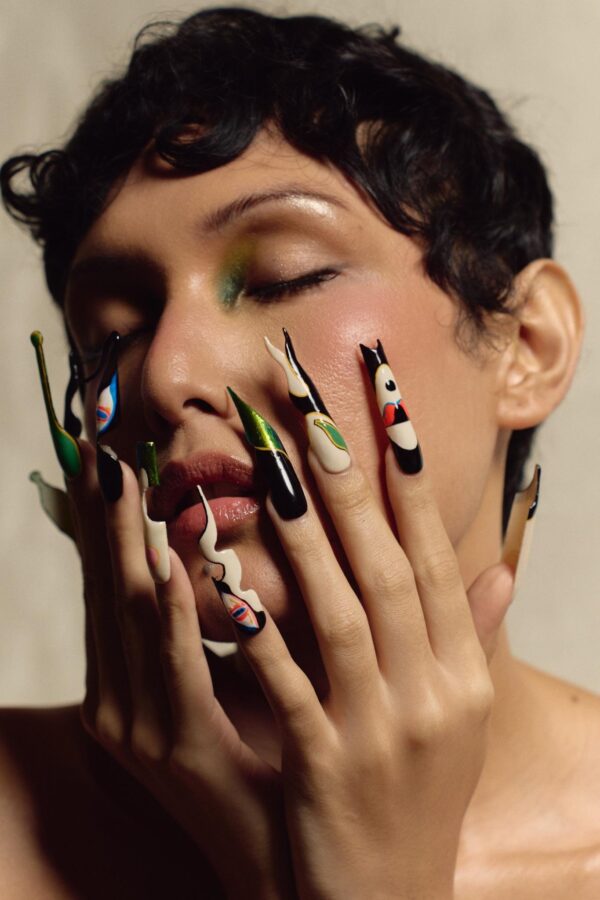 Model with hands to face wearing Jer Dee press-on nails