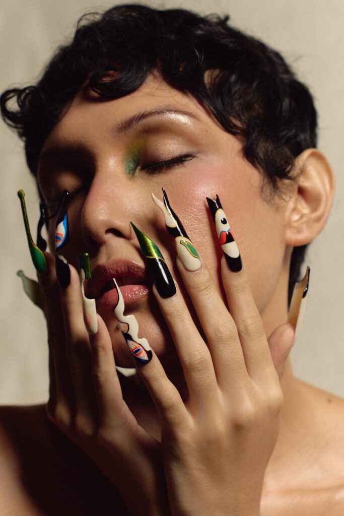 Model with hands to face wearing Jer Dee press-on nails