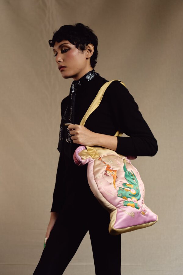 Model carrying the pink quilted vase bag on the shoulder