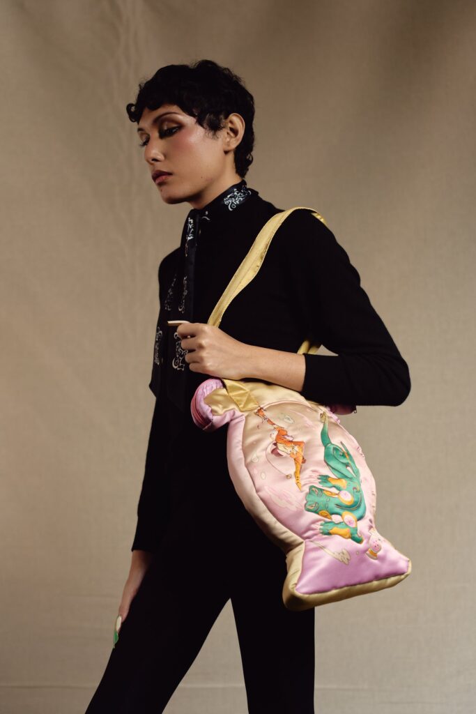 Model carrying the pink quilted vase bag on the shoulder