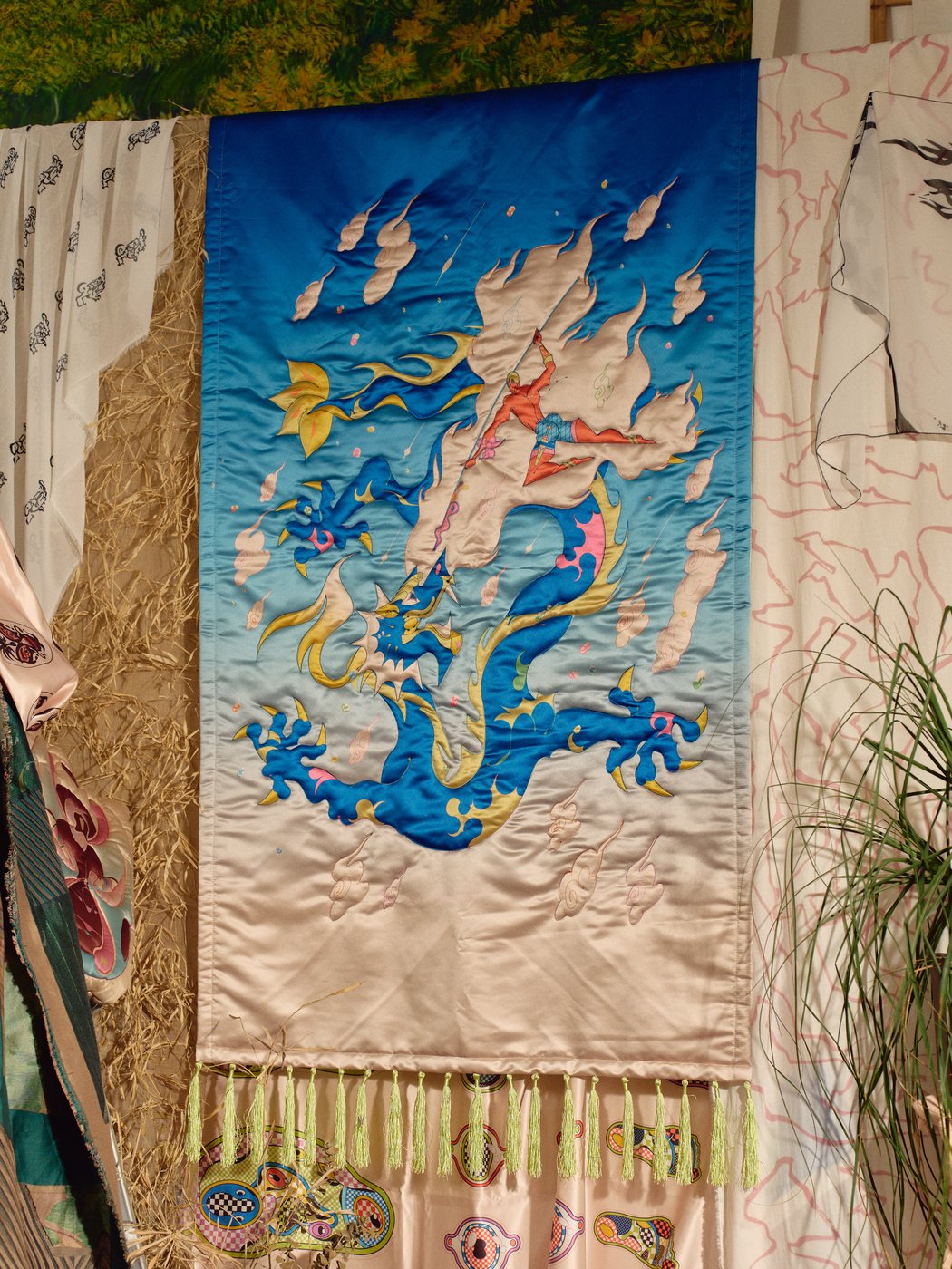 Dragon Tapestry hanging among Jer Dee scarves and prints