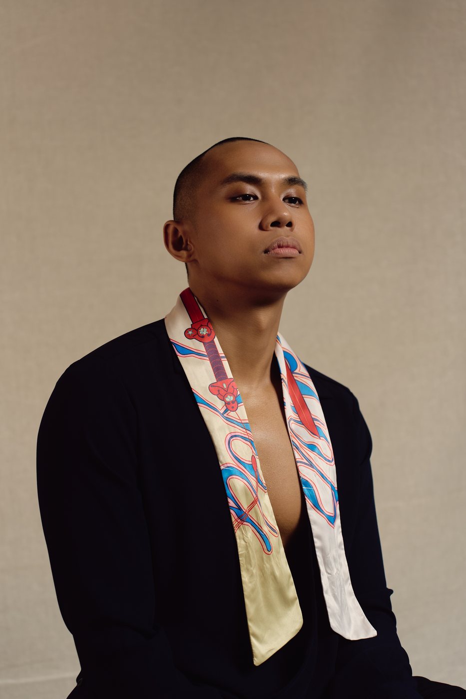 Model wearing the Sword skinny scarf over a dark jacket