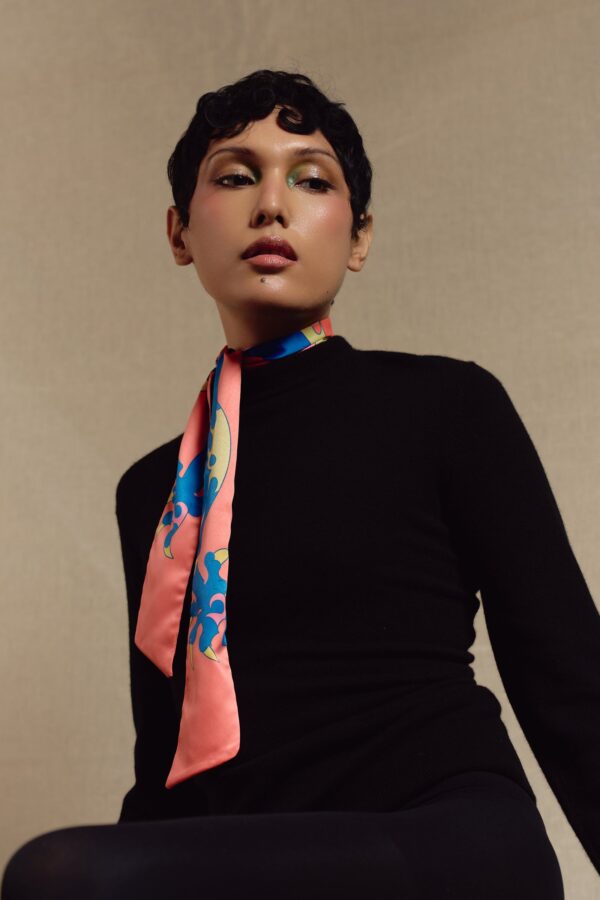 Model wearing the Dragon skinny scarf in coral and blue